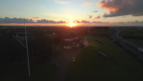 Sunset-behind-old-building-on-hill-with-rise-up-over-urban-area-of-Fleetwood-UK