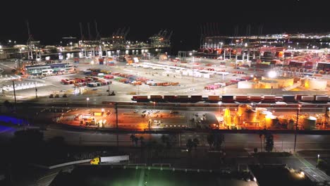 drone-view-of-Long-Beach-shipyard-at-night-showcasing-towering-cranes-and-rows-of-cargo-containers