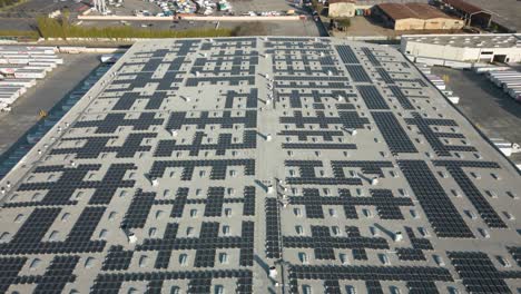 drone-time-lapse-of-solar-panels-on-a-bustling-distribution-center-roof-top,-showcasing-clean-energy-and-sustainability-in-action