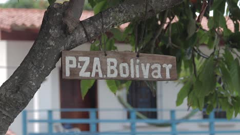 View-of-a-small-wooden-sign-with-the-name-of-Plaza-Bolivar,-located-in-the-town-of-Chuao,-Venezuela