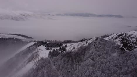 Drone-climbing-over-snowy-mountains