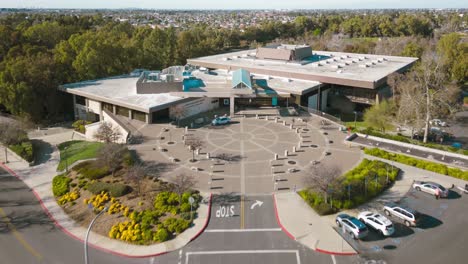 Discover-the-eco-friendly-side-of-the-Huntington-Beach-Central-Library-in-this-stunning-drone-time-lapse,-showcasing-its-solar-panels-and-library-patrons
