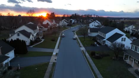Aerial-shot-of-golden-sunset-over-upscale-housing-neighborhood-in-America