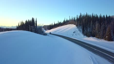 Exploring-the-majestic-and-snow-covered-landscape-of-the-Glenn-Highway-of-Alaska,-the-view-is-breathtaking-as-you-drive-through-this-winter-wonderland