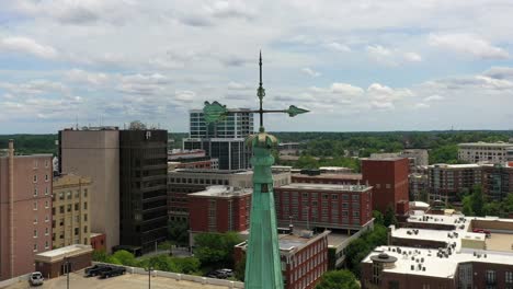 Close-up-aerial-orbit-around-green-church-steeple-in-Greenville-South-Carolina-downtown