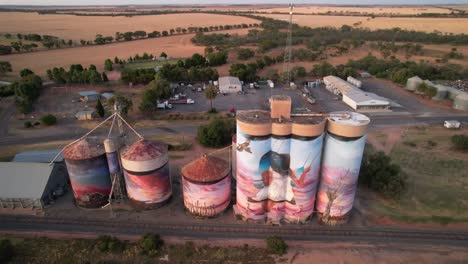 Colourfully-painted-grain-silo-aerial-toward-pan-down-Sea-lake,-Australia