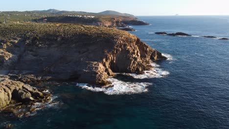 Sensational-aerial-view-of-Sardinia-rocky-coastline-in-Sant'Antioco,-golden-hour