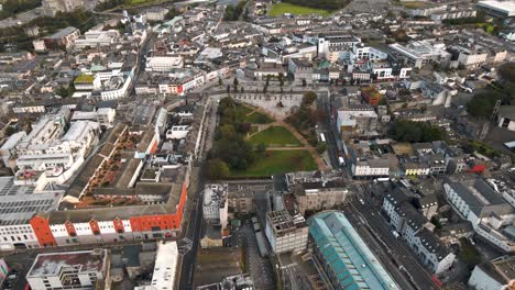 Aerial-drone-tracking-shot-moving-away-from-Eyre-Square-park-in-Galway-City