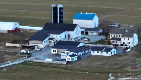 Long-aerial-zoom-of-American-farm-in-winter