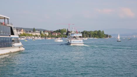 Ferries,-boats-and-ships-sailing-on-Lake-Zurich-blue-waters-in-summer