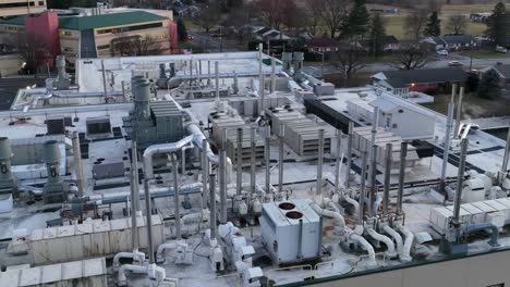 Aerial-shot-of-steam-and-smoke-fuming-out-of-steel-HVAC-appliances-on-lab