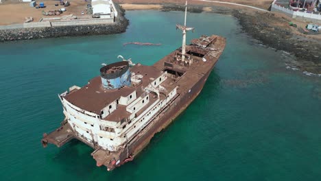 Spectacular-aerial-view-flight-Abandoned-destroyed-ghost-ship-Shipwreck-on-beach-sandbank-Lanzarote-Canary-Islands,-sunny-day-Spain-2023