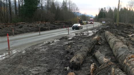 A-section-of-Highway-7-hard-hit-by-a-devastating-mudslide,-traffic-cautiously-navigating-through-a-section-of-road-which-has-been-covered-in-dirt-and-debris-from-the-natural-disaster,-Agassiz,-Canada