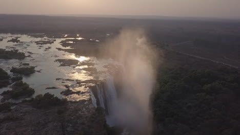Morning-aerial:-Africa's-Victoria-Falls-with-mist-backlit-by-sunshine
