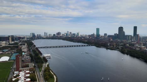 Aerial-view-of-the-Charles-river-and-the-Boston-city-skyline---circling,-drone-shot