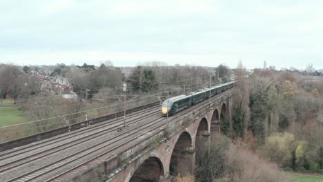 follow-drone-shot-of-Great-western-railway-javelin-high-speed-train-over-Wharncliffe-viaduct-London