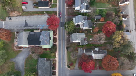 Top-down-aerial-of-homes-in-suburbia-with-colorful-autumn-trees