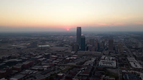 Aerial-drone-view-of-highrise-in-downtown-Oklahoma-with-a-vibrant-evening-horizon