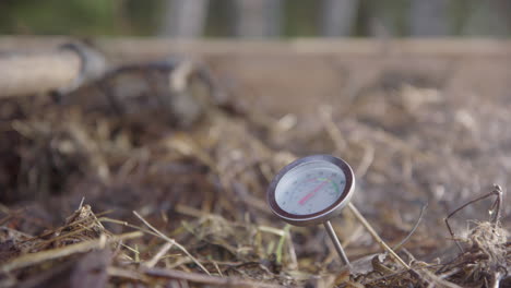 SLOW-MOTION---steam-rises-around-the-compost-thermometer