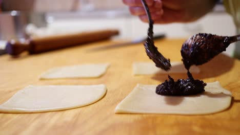 filling-the-traditional-italian-pastries-with-chocolate-filling,-close-up-footage