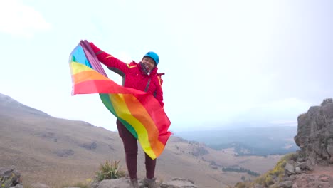 Young-woman-with-LGBT-rainbow-flag-in-the-mountains