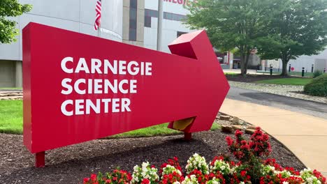 Red-arrow-showing-the-direction-to-Carnegie-Science-Center,-a-famous-children's-museum-in-Pittsburgh-Pennsylvania