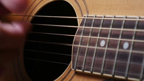 Close-up-shot-of-man's-hand-playing-guitar-with-picking-technic