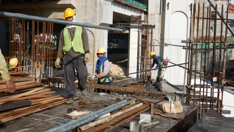 Construction-workers-fabricating-steel-reinforcement-bars-at-the-construction-site