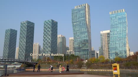Incheon-skyline-above-Central-Park's-Busking-stage-for-street-performers-on-a-clear-day---establishing-shot