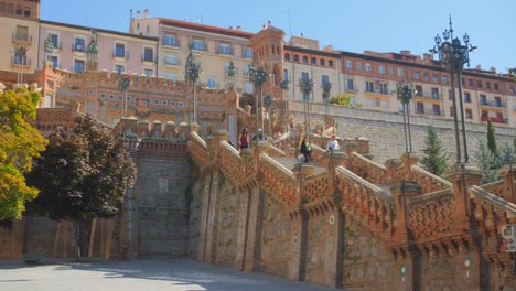 Looking-up-famous,-historic-and-colorful-stairs-of-Escalinata-de-Teruel-in-the-Teruel-old-town-in-Aragon,-Spain