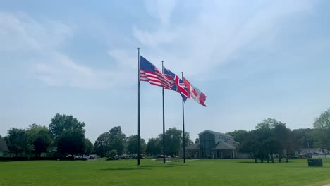 National-Flags-waving-in-the-air-at-Perry's-Victory-International-Peace-Memorial,-Put-in-Bay-South-Bass-island-Ohio-USA