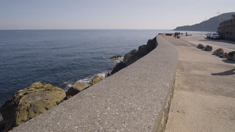 Majestic-rocky-coastline-and-concrete-walkway-in-city-of-San-Sebastian