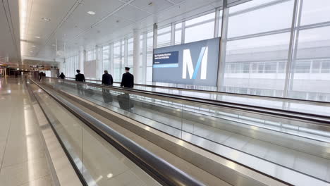 pilots-and-airline-employees-on-moving-sidewalk-at-munich-airport
