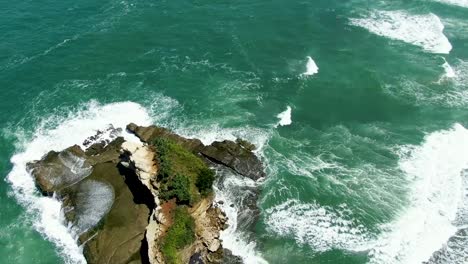 Scenic-rock-at-popular-Klayar-beach-in-East-Java,-Indonesia,-aerial-reveal-shot