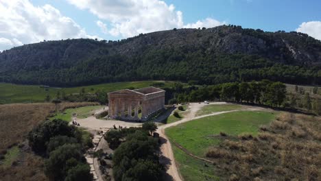 Fly-in-Aerial-of-an-Ancient-Greek-Temple-and-its-Lush-Landscape-on-a-Sunny-Day