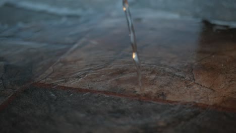 water-is-poured-onto-a-marble-counter
