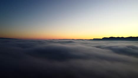 Beautiful-aerial-shot-of-a-sunset-above-clouds-in-the-Pyrenees-mountains