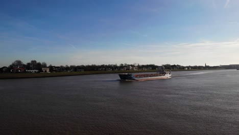 Aerial-Dolly-Across-River-Noord-With-Wilson-Mersey-Cargo-Ship-Passing-Along