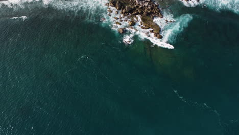 Aerial-birdseye-static-shot-over-sea-waves-in-sunny-day