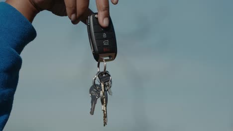 A-set-of-keys-being-held-up-by-a-car-key-fob