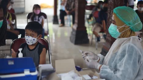 Yogyakarta,-Indonesia---Dec-20,-2021-:-an-elementary-school-boy-is-receiving-a-covid19-vaccine