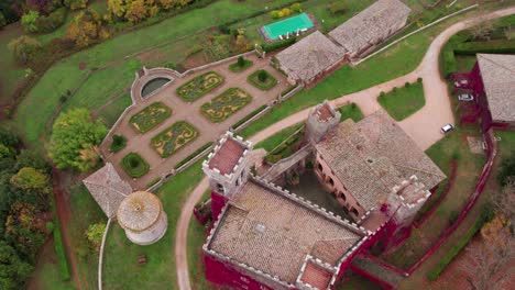 Castello-di-Celsa,-medieval-Italian-castle-on-hill-top-with-gardens,-aerial