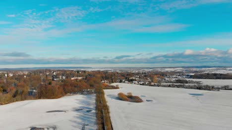a-slow-aerial-drone-shot-in-a-winter-landscapre-with-snow-in-northern-germany