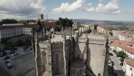 Heritage-landmark-in-Portugal,-Guarda-catholic-church-close-up,-aerial-view-of-the-rooftop