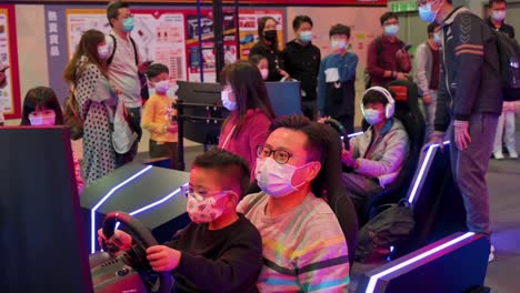 Families-play-themed-racing-videogames-during-the-International-Motor-Expo-showcasing-thermic-and-electric-cars-and-motorcycles-in-Hong-Kong