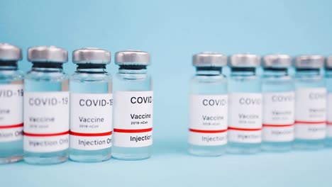 Covid-19-vaccination-vial,-distribution-and-manufacture-of-the-coronavirus-new-cure,-vaccine-production-line