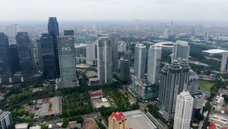 Forward-aerial-of-SCBD-business-area-skyscrapers-in-Jakarta,-Indonesia