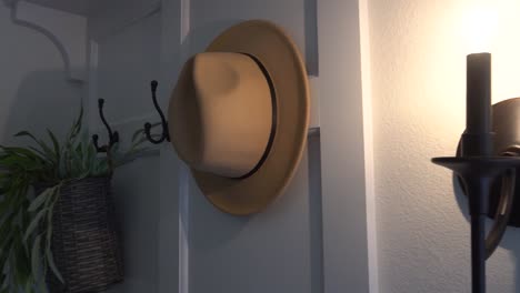 Fedora-hanging-on-the-back-of-a-door-in-a-home