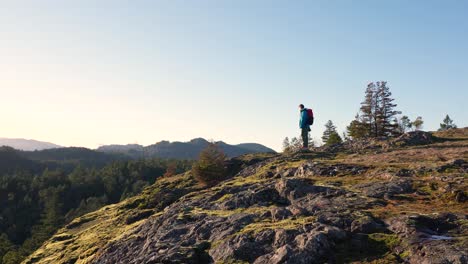 Male-Hiker-on-a-Rock-Bluff-Ridge-on-Vancouver-Island,-Canada,-Lone-Tree-Hill