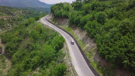 Van-driving-through-the-winding-roads-of-Valbona-Kukes-in-Albania,-Eastern-Europe